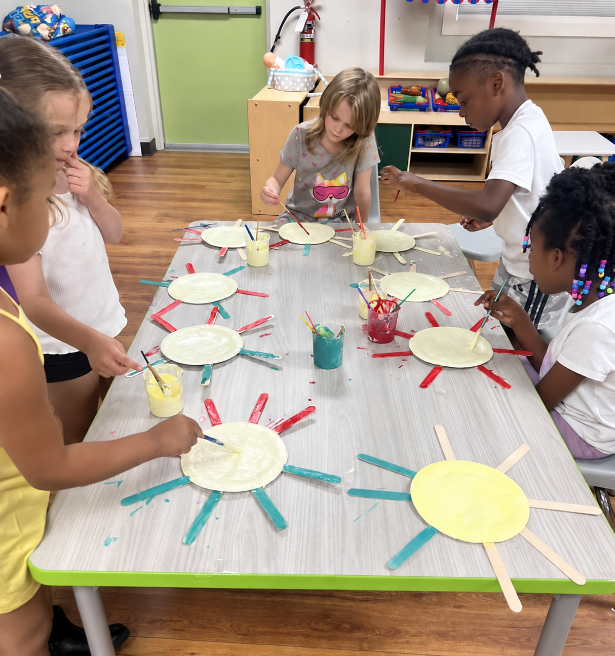 Children creating colorful art together around a table at Building Blocks